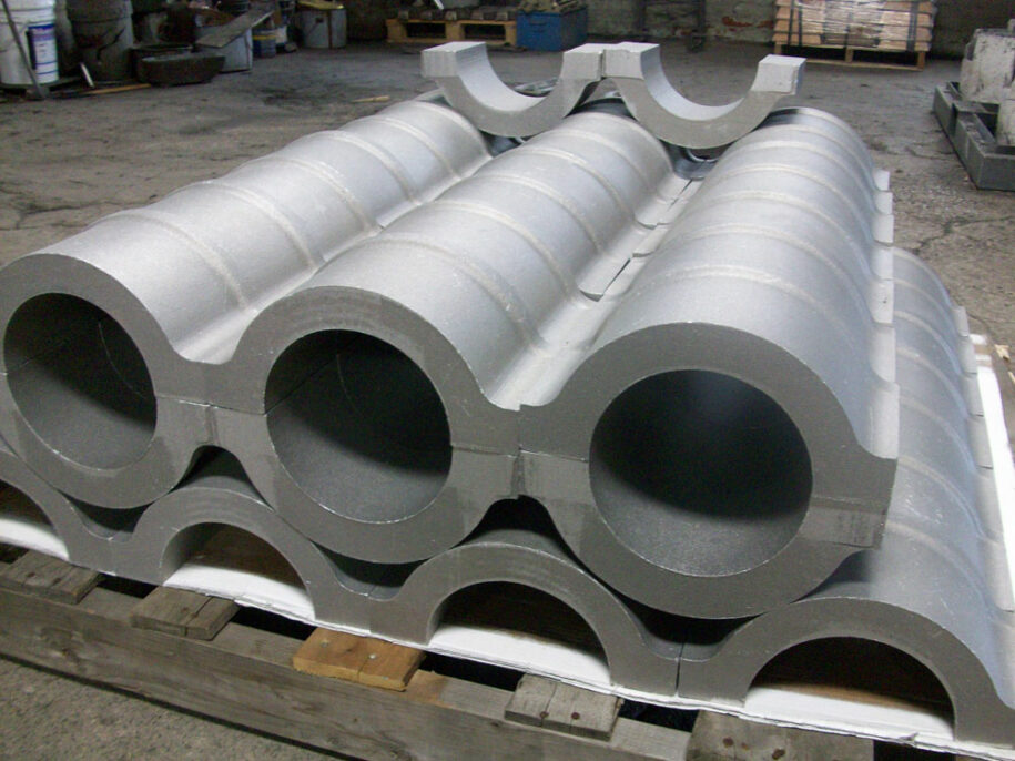 Large precision-cast aluminum components stacked for industrial use. High-strength non-ferrous metal castings designed for durability in aerospace, automotive, and heavy machinery applications.
